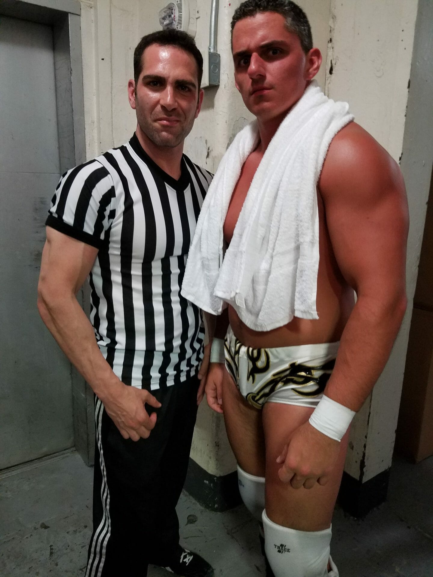 Israel Joffe in a referee shirt photographed with a wrestler after a match in Brooklyn