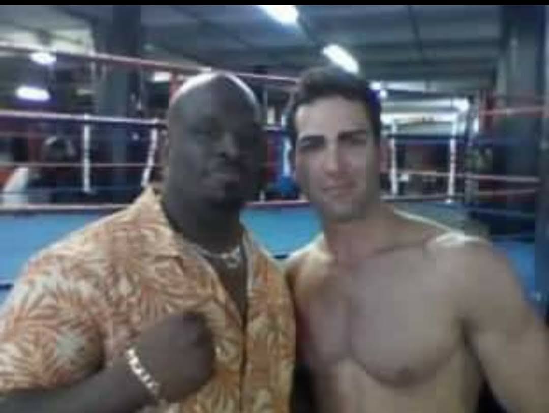 Israel Joffe inside a wrestling ring with a training partner at a Brooklyn gym